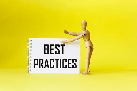 Best practices, the text is written on a notebook, next to a wooden doll on a Stock Photos