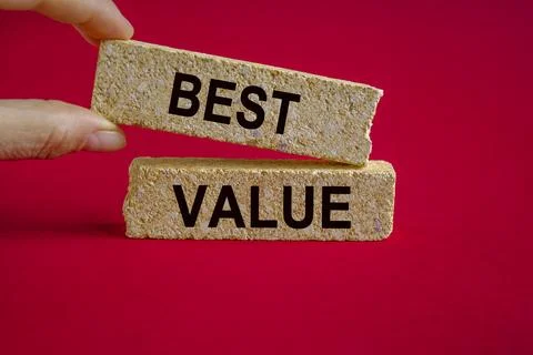 Best Value symbol. Brick blocks with words Best Value. Businessman hand Stock Photos