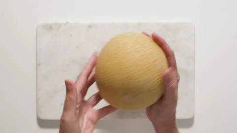 Best way to peel a melon. Flat lay video, woman hands Stock Footage 136711090