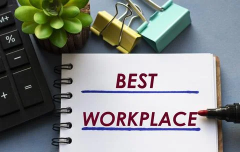 BEST WORKPLACE - words is written in a notebook with a marker, calculator, cl Stock Photos