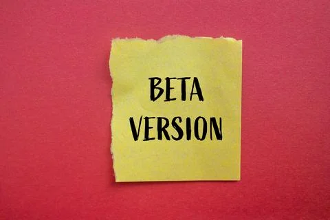 Beta version words written on ripped yellow paper piece with red background.  Stock Photos