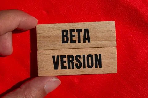 Beta version words written on wooden blocks with red background. Conceptual b Stock Photos