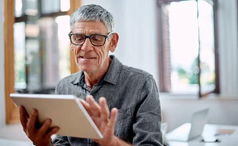Better accessibility leads to more productivity. a senior businessman using a Stock Photos