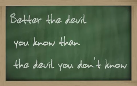 "   better the devil you know than the devil you don't know " written on a bl Stock Photos