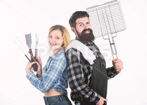 A better grill for a better cook. Happy hipster and sexi girl holding picnic set Stock Photos