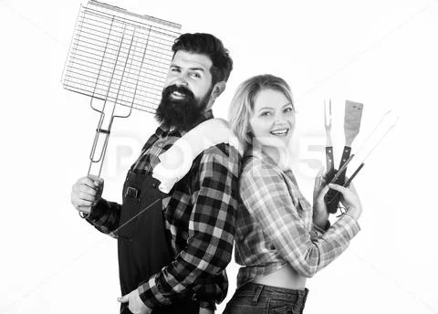 A better grill for a better cook. Happy hipster and sexi girl holding picnic set Stock Photos