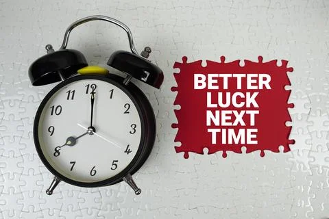 Better Luck Next Time text with alarm clock on red background Stock Photos