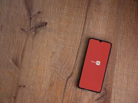 BetterMe app launch screen with logo on the display of a black mobile smartph Stock Photos