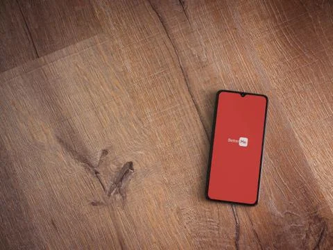 BetterMe app launch screen with logo on the display of a black mobile smartph Stock Photos