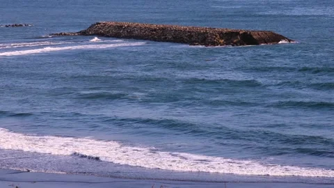 Between beach  breakwater,Continuous rolling wave scene.Picturesque seascape.4K Stock Footage 259693350