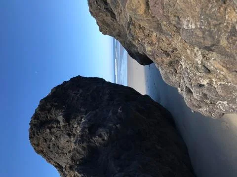 Between the beach rocks Stock Photos