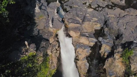 In between the rocks highest waterfall point zoom out aerial footage Stock Footage 100654688