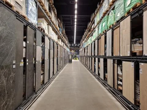 Between rows of goods in a construction hypermarket Stock Photos