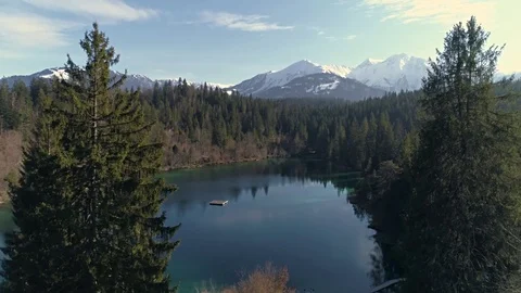 Between Trees Lake Mountain Aerial 4k Stock Footage 77454266