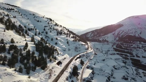 Between two mountains, snowy, trees and roads Stock Footage 240496187