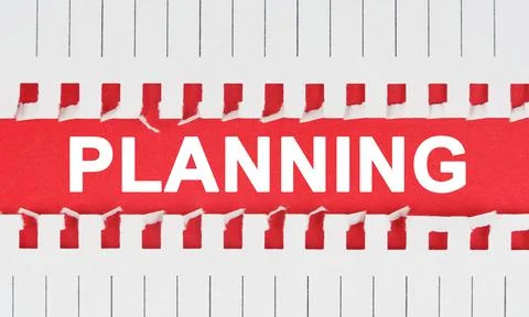 Between two sheets of notebook on a red background the inscription - PLANNING Foto stock