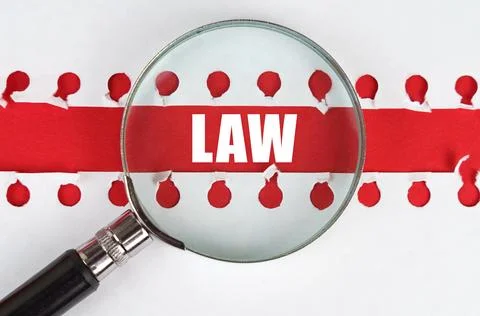 Between two sheets from a notebook on a red stripe with the inscription - law 스톡 사진