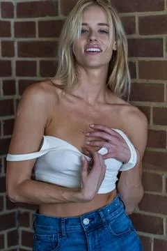 A Beuatiful Blonde Model Poses Topless Outdoors Stock Photos