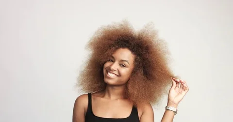 Beuayt black woman with a huge afro hair having fun smiling and touching her Stock Footage