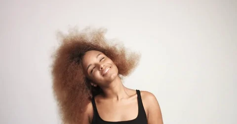 Beuayt black woman with a huge afro hair having fun smiling and dancing Stock Footage