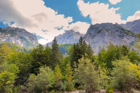 A beutiful landscape in the mountains, clouds above peaks and forest in Stock Photos