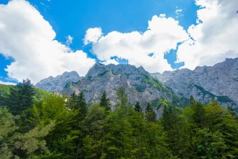 A beutiful landscape in the mountains, clouds above peaks and forest in Stock Photos
