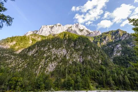 A beutiful landscape in the mountains, clouds above peaks and forest in Stock Photos