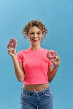 Beutiful model showing two tasty donaughts. Stock Photos