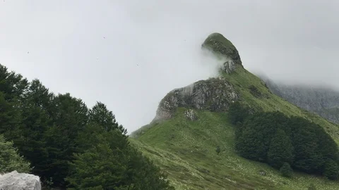 In a beutiful mountain location wind move clouds approaching rain Stock Footage 90780625