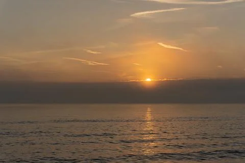 Beutiful sunset with orange sky over the sea Stock Photos