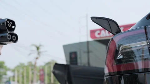 BEV car plugged in with charging station to recharge battery with electricity Video stock 272298197