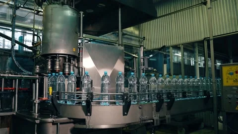 Beverage factory interior. Conveyor with plastic water bottles Видео 149670511