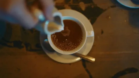 Beverage Pouring: Ceramic Cup, Matching Saucer, and Metal Spoon 库存影片 339267660