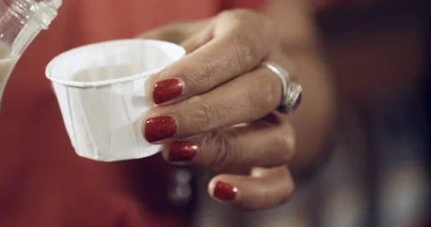 Beverage sample for customers at grocery store in small paper cup Stock Footage 118844751