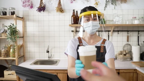 Beverage shop worker offering takeaway coffee Stock Footage 205874903