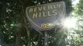 Beverly Hills sign handheld with sun and lens flare HD Footage