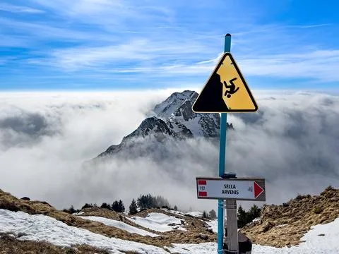 Beware of falling sign at the cliff side Stock Photos