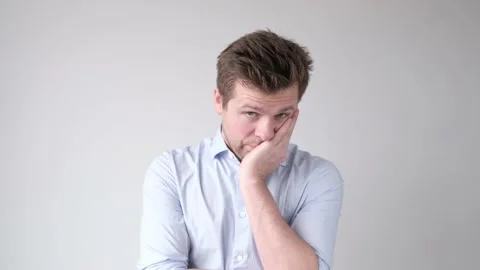 Bewildered displeased sorrorful man going to cry as sees no way out in difficult Stock Footage 119680127