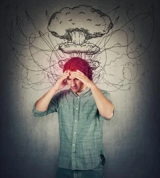 Bewildered man head explosion concept. Guy suffering headache, hands to foreh Stock Photos