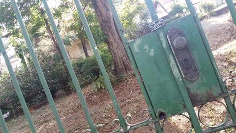 Beyond the locked green gate Stock Photos