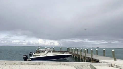 Bhamas Dock - Cost Guard helicopter flies by Stock Footage 258689306