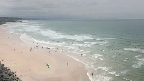 Biarritz beach surf lessons on cloudy day Stock Footage 137973096