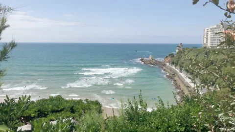 Biarritz beach wide shot waves and surfers Stock Footage 137972853