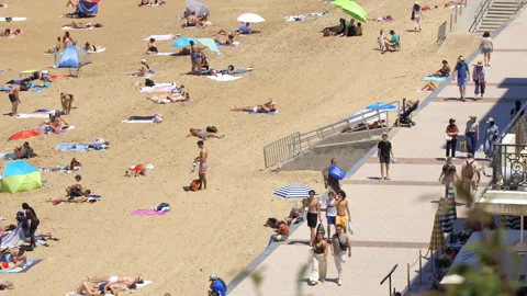 Biarritz seafront promenade alongside crowds sunbathing on the Grande Plage Stock Footage 340606381