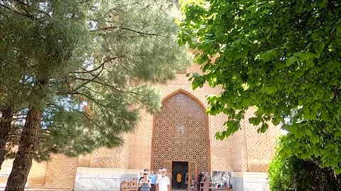 Bibi-Khanym mosque with turquoise dome framed by green trees Stock Footage 336846207