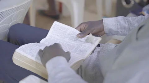 Bible with african hands Stock Footage 231525646