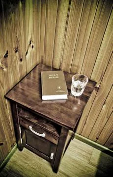 Bible on bed side table Stock Photos