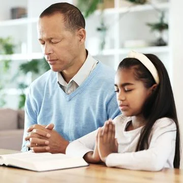 Bible books, family and child in prayer for support, faith and christian worship Stock Photos