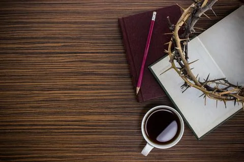 Bible with coffee cup, small note book, crown of thorns on wooden background Stock Photos