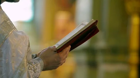 The Bible in the hands of the priest 2 Stock Footage 75073672